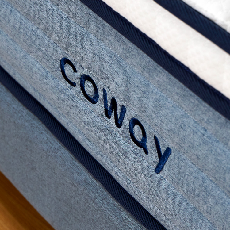 a-close-up-view-of-the-coway-logo-on-the-coway-prime-lite-series-mattress