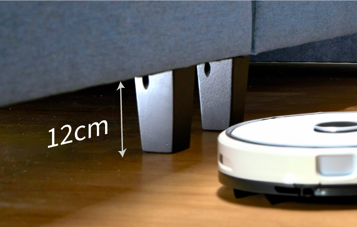 an-image-of-a-gap-between-the-bed-and-the-wooden-floor-with-the-measurement-of-12cm-and-a-robot-vacuum-cleaner-at-the-side